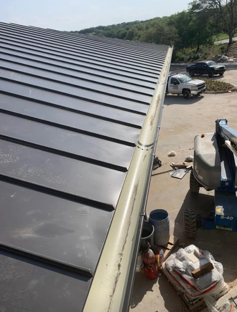Standing seam panel and gutter detail on a metal roofing jobsite in Parma